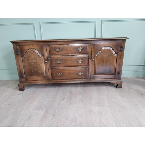 197 - Good quality oak side cabinet with three drawers flanked by two blind doors raised on bracket feet i... 