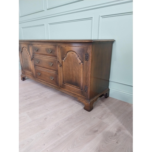 197 - Good quality oak side cabinet with three drawers flanked by two blind doors raised on bracket feet i... 