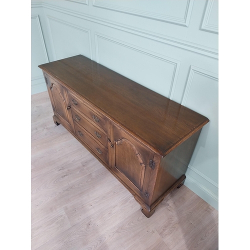 197 - Good quality oak side cabinet with three drawers flanked by two blind doors raised on bracket feet i... 