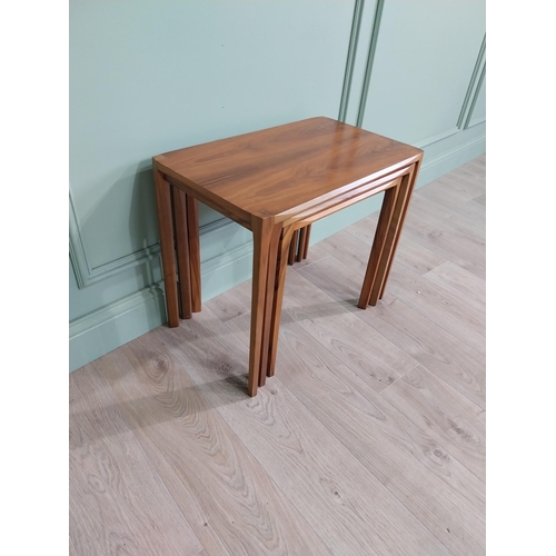 22 - Mid-century teak nest of three tables raised on square legs {52 cm H x 64 cm W x 39 cm D}.