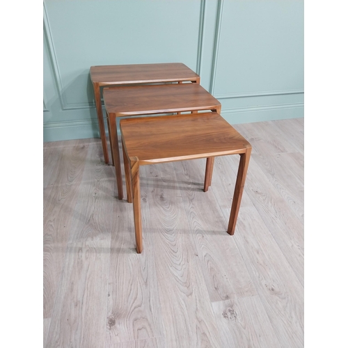 22 - Mid-century teak nest of three tables raised on square legs {52 cm H x 64 cm W x 39 cm D}.