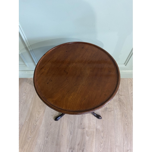 242 - Irish Georgian mahogany tilt  top wine table raised on turned column and three out swept feet. {71 c... 