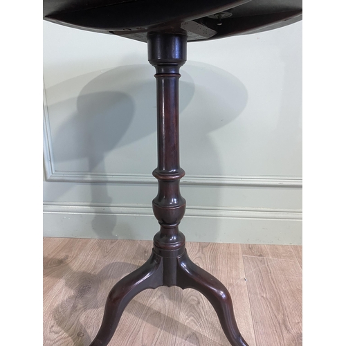 242 - Irish Georgian mahogany tilt  top wine table raised on turned column and three out swept feet. {71 c... 