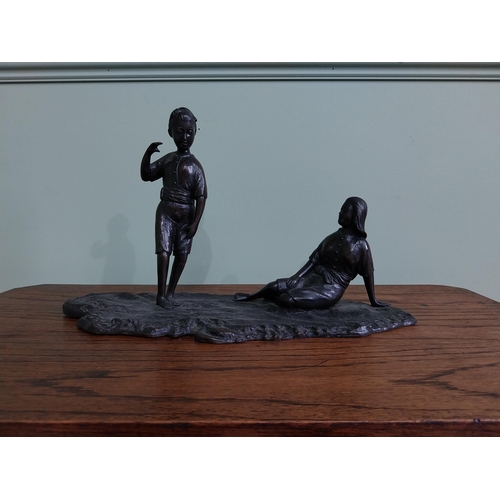 256 - Bronze figural group of a Boy and Girl mounted on a wooden plinth {23 cm H x 36 cm W x 18  cm D}.