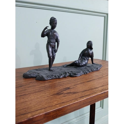 256 - Bronze figural group of a Boy and Girl mounted on a wooden plinth {23 cm H x 36 cm W x 18  cm D}.