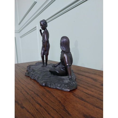 256 - Bronze figural group of a Boy and Girl mounted on a wooden plinth {23 cm H x 36 cm W x 18  cm D}.