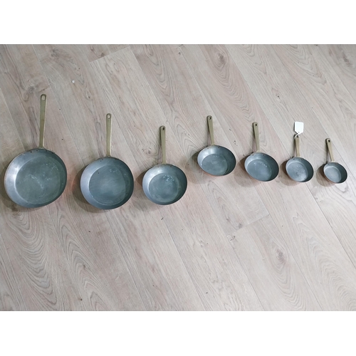 3 - Set of seven copper saucepans with brass handles {43 cm H x 23 cm W and 20 cm H x 9 cm W}.