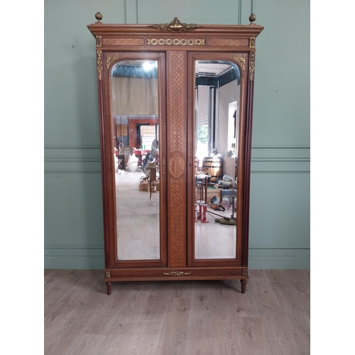 319 - 19th C. French kingwood wardrobe with two mirrored doors and ormolu mounts raised on turned feet {23... 