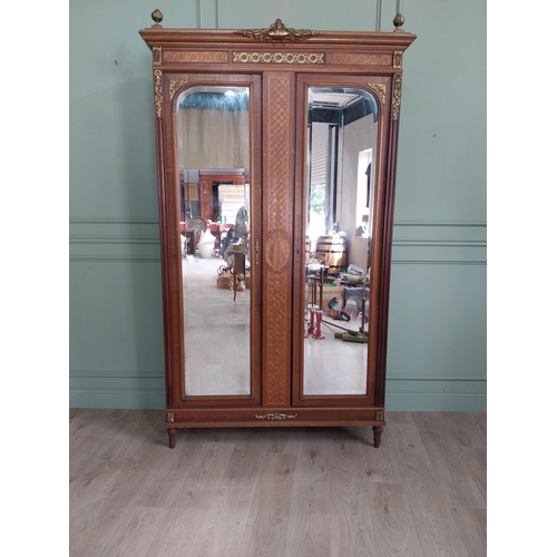 319 - 19th C. French kingwood wardrobe with two mirrored doors and ormolu mounts raised on turned feet {23... 