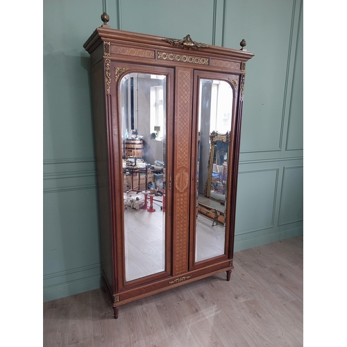 319 - 19th C. French kingwood wardrobe with two mirrored doors and ormolu mounts raised on turned feet {23... 