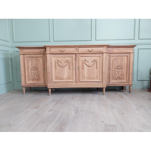 354 - Good quality early 20th C. bleached oak side board with two short drawers over four blind doors rais... 