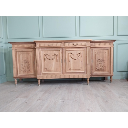 354 - Good quality early 20th C. bleached oak side board with two short drawers over four blind doors rais... 