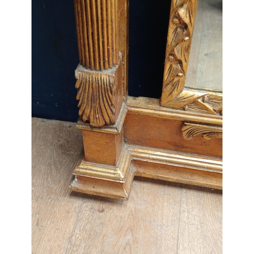 355 - Giltwood pillar mirror decorated with ornate floral and scroll carved design {H 238cm x W 112cm xx D... 