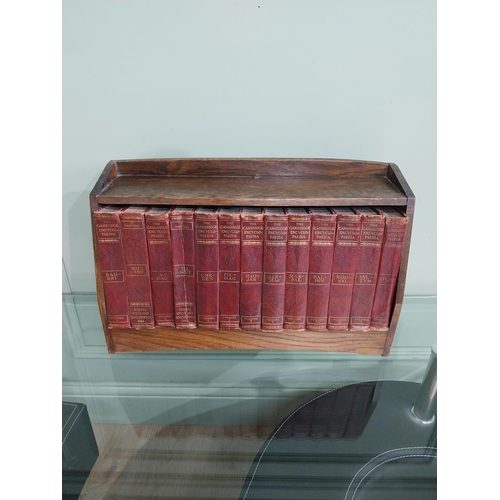 384 - 1940's oak book trough and set of thirteen Cambridge encyclopaedias'.