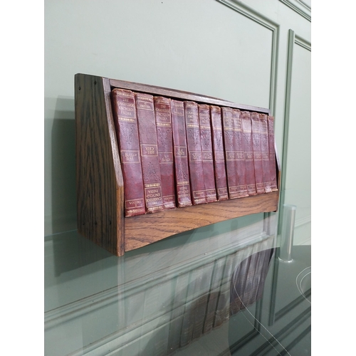 384 - 1940's oak book trough and set of thirteen Cambridge encyclopaedias'.