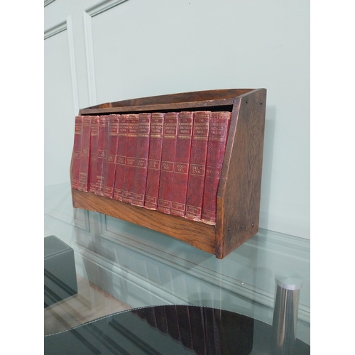 384 - 1940's oak book trough and set of thirteen Cambridge encyclopaedias'.