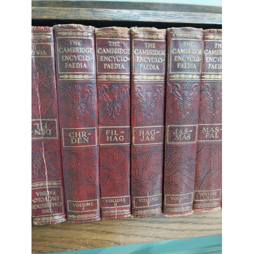 384 - 1940's oak book trough and set of thirteen Cambridge encyclopaedias'.