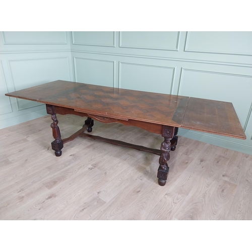 388 - Edwardian oak drawer leaf dining table raised on carved legs and single stretcher {78 cm H x 106 cm ... 