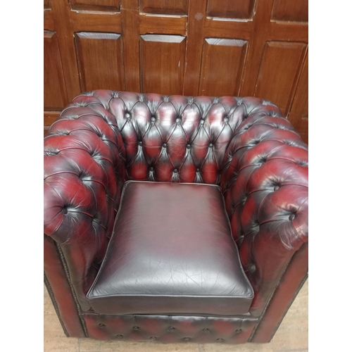 397 - Hand quilted oxblood Chesterfield club chair raised on casters {H 70cm x W 97cm x D 84cm } - NOT AVA... 