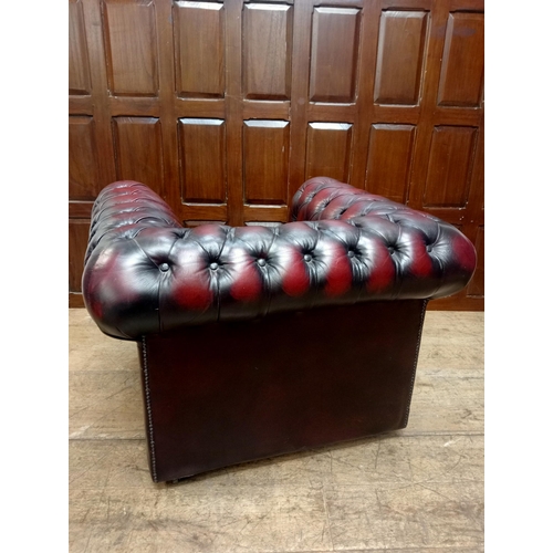 397 - Hand quilted oxblood Chesterfield club chair raised on casters {H 70cm x W 97cm x D 84cm } - NOT AVA... 