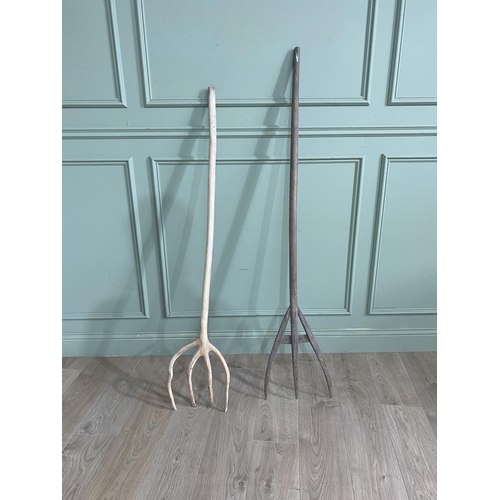 402 - Two antique wooden hay forks {160 cm H x 34 cm W and 146 cm H x 30 cm W}.