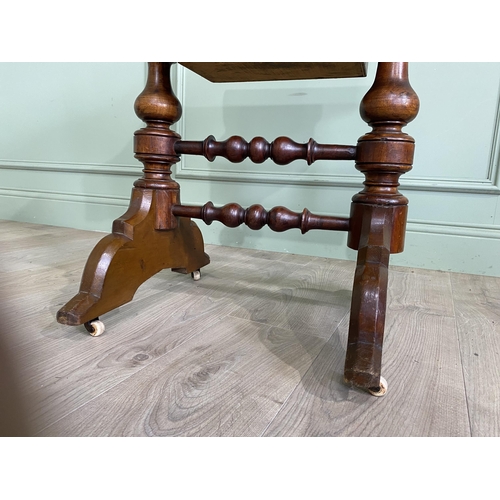 421 - Victorian burr walnut games and sewing table raised on turned legs, single stretcher and castors {72... 