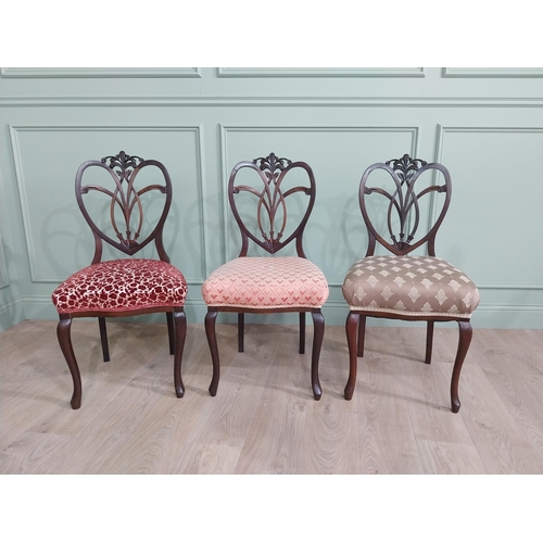 444 - Set of three Edwardian mahogany shield back side chairs with upholstered seat raised on cabriole leg... 