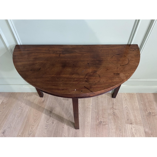 453 - Georgian mahogany demi-lune side table raised on square legs {73 cm H x 107 cm W x 52 cm D}.