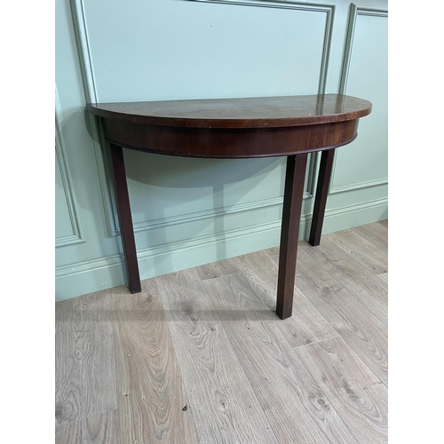 453 - Georgian mahogany demi-lune side table raised on square legs {73 cm H x 107 cm W x 52 cm D}.