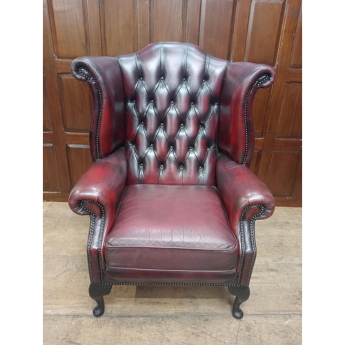 466 - Deep buttoned leather wingback fireside chair raised on Queen Ann legs {H 112cm x W 90cm x D 90cm } ... 