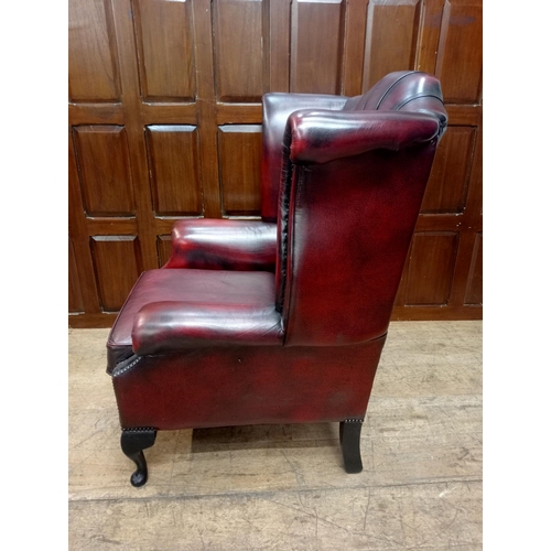 466 - Deep buttoned leather wingback fireside chair raised on Queen Ann legs {H 112cm x W 90cm x D 90cm } ... 