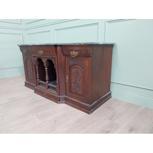 467 - Edwardian carved mahogany side cabinet with marble top and three short drawers above two blind doors... 