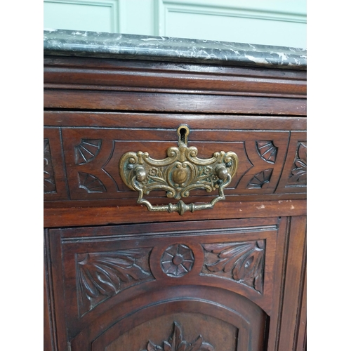 467 - Edwardian carved mahogany side cabinet with marble top and three short drawers above two blind doors... 