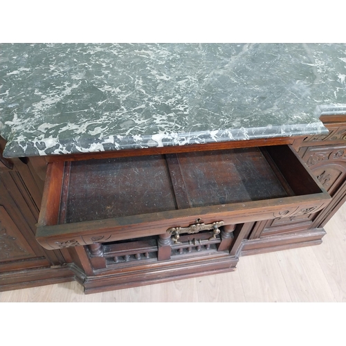 467 - Edwardian carved mahogany side cabinet with marble top and three short drawers above two blind doors... 