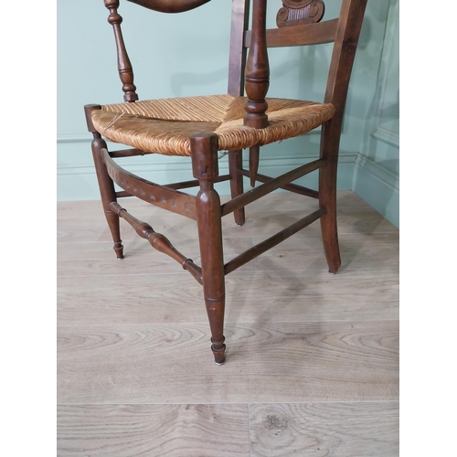 471 - Edwardian carved walnut open armchair with rushed upholstered seat raised on turned legs {92 cm H x ... 