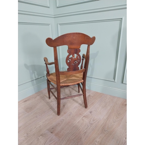 471 - Edwardian carved walnut open armchair with rushed upholstered seat raised on turned legs {92 cm H x ... 