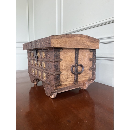 480 - Early 20th C. Indian hardwood metal bound trunk with wrought iron handles raised on wheels {31 cm H ... 