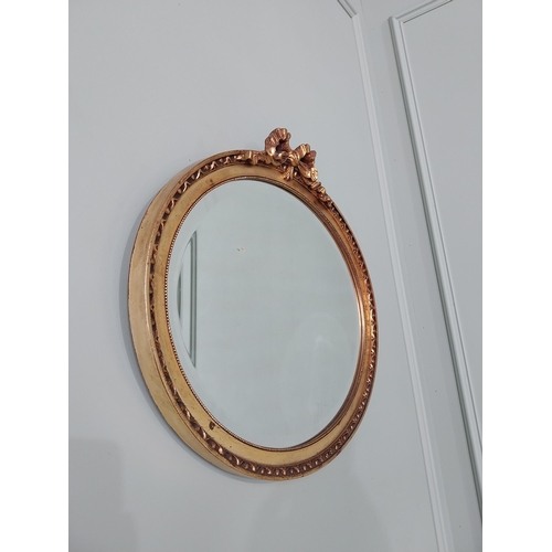 531 - French gilt oval wall mirror {51 cm H x 56 cm W}.