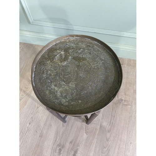 536 - Early 20th C. Middle Eastern oak coffee table with embossed brass top {52 cm H x 34 cm Dia.}.