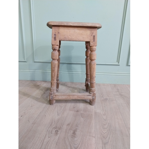 554 - Two early 20th C. pine stools raised on turned legs {60 cm H x 38 cm W x 30 cm D and 33 cm H x 22 cm... 