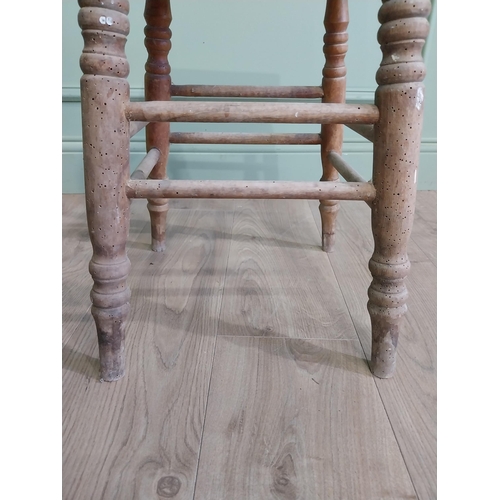 554 - Two early 20th C. pine stools raised on turned legs {60 cm H x 38 cm W x 30 cm D and 33 cm H x 22 cm... 