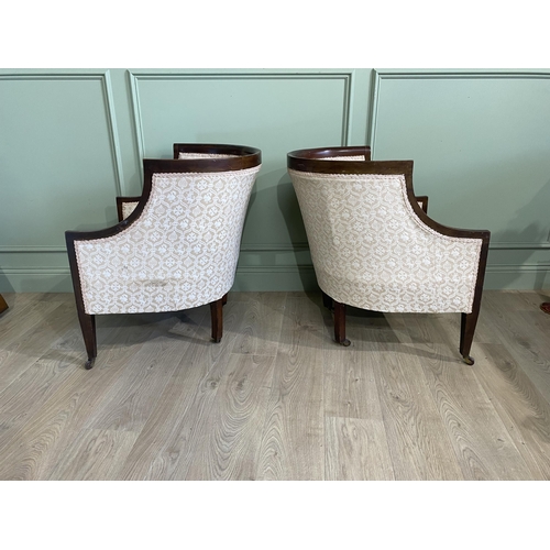 562 - Pair of Edwardian mahogany and satinwood inlaid upholstered armchairs raised on square tapered legs ... 