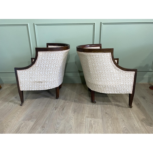 562 - Pair of Edwardian mahogany and satinwood inlaid upholstered armchairs raised on square tapered legs ... 