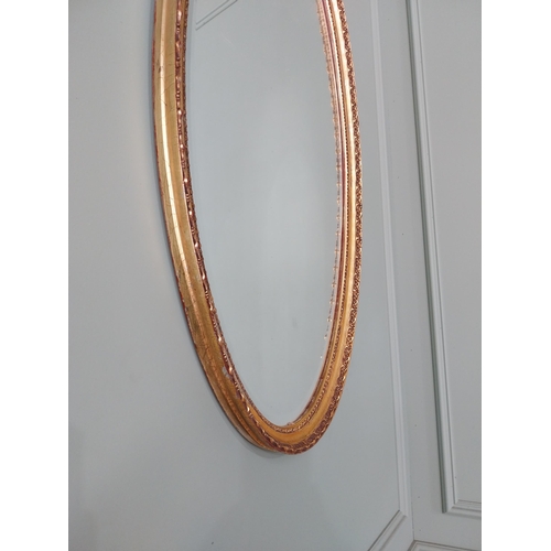 574 - Giltwood wall mirror in the 19th C. style {97 cm H x 51 cm W}.