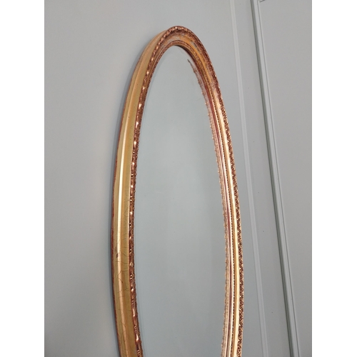 574 - Giltwood wall mirror in the 19th C. style {97 cm H x 51 cm W}.