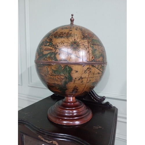 582 - Globe on wooden base in the form of a drinks' cabinet. {47 cm H x 32 cm Dia.}.