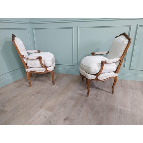 583 - Pair of Edwardian French carved walnut open armchairs with silk embroidered upholstery raised on cab... 