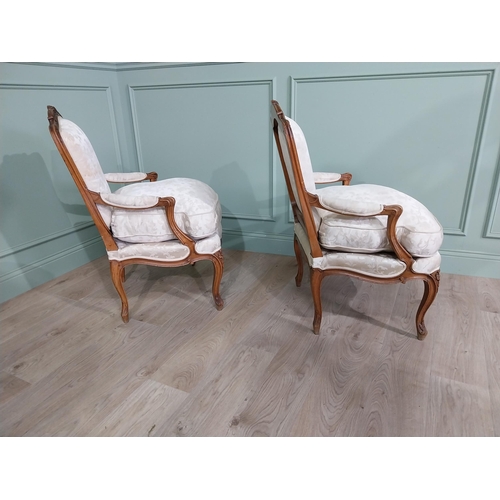 583 - Pair of Edwardian French carved walnut open armchairs with silk embroidered upholstery raised on cab... 