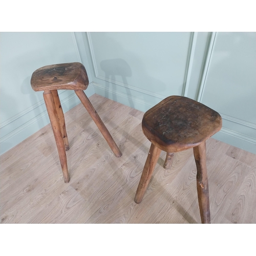 611 - Pair of vintage rustic hard wood three legged stools {80 cm H x 46 cm W x 37 cm D}.