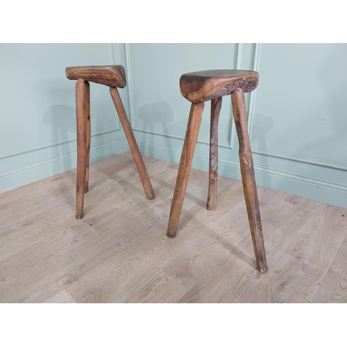 611 - Pair of vintage rustic hard wood three legged stools {80 cm H x 46 cm W x 37 cm D}.